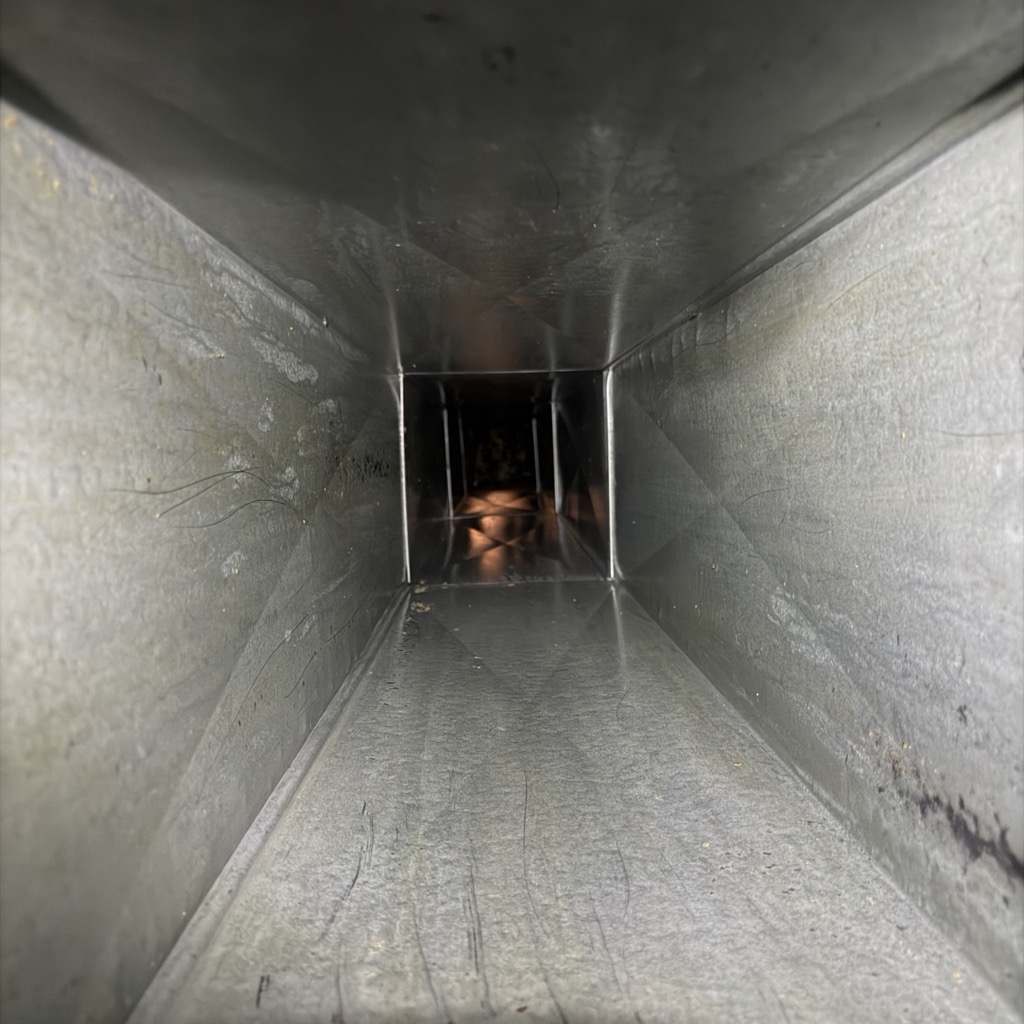 The same exhaust duct run cleaned back to bare metal